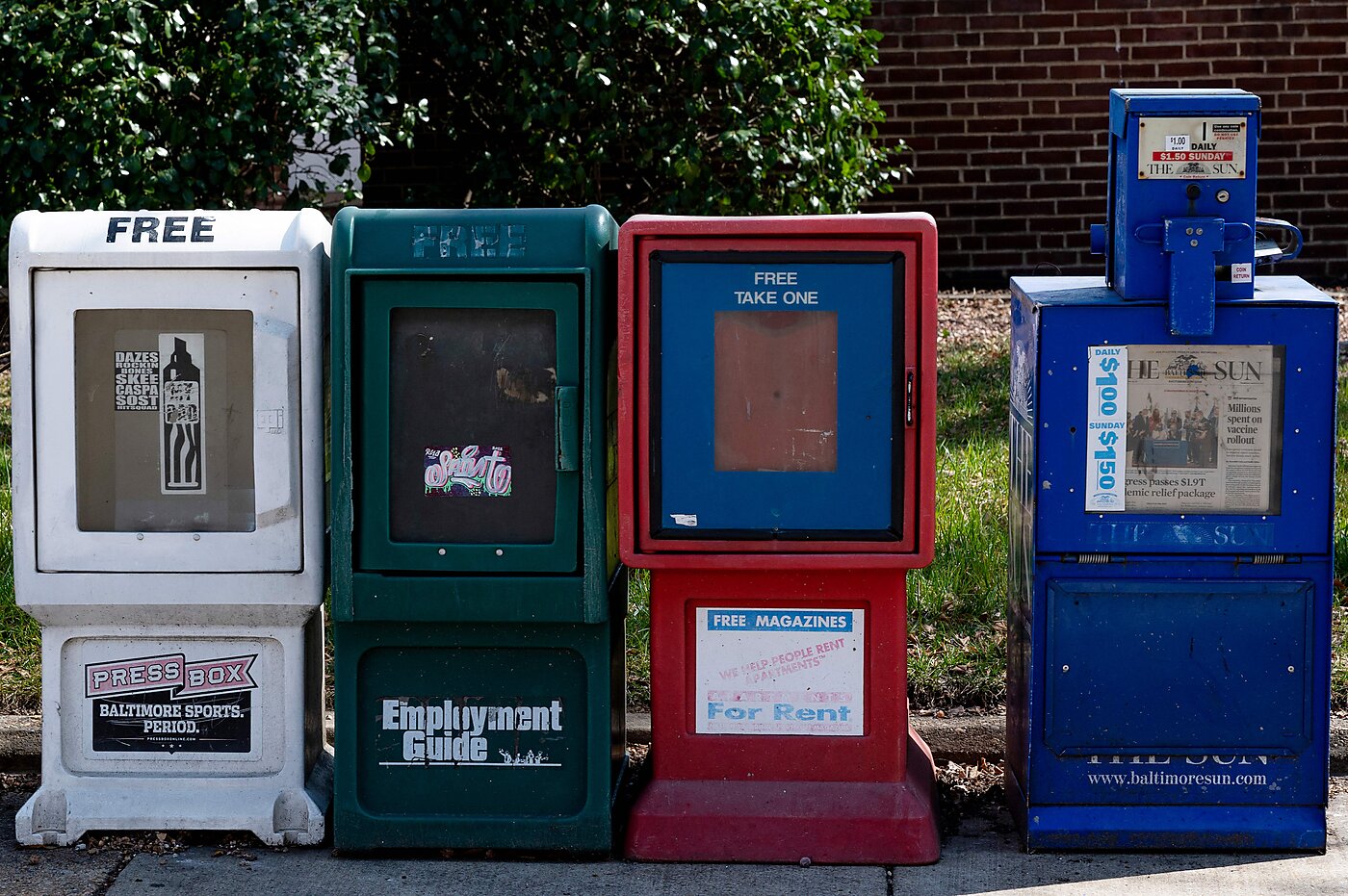 Newspaper bins on a sidewalk