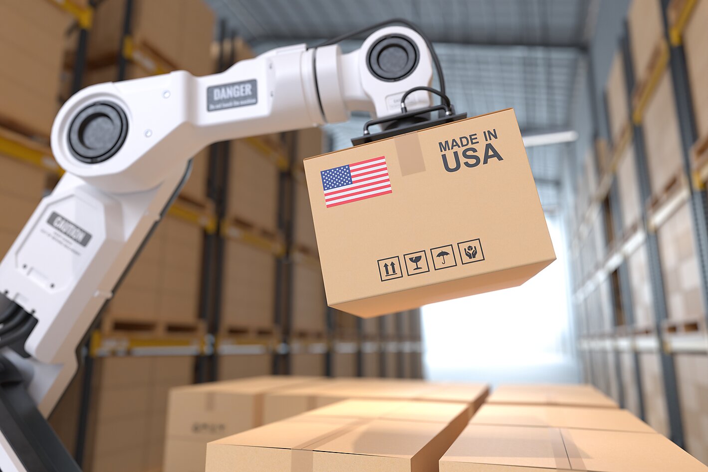 A robot arm in a storehouse picking up a cardboard box Made in USA