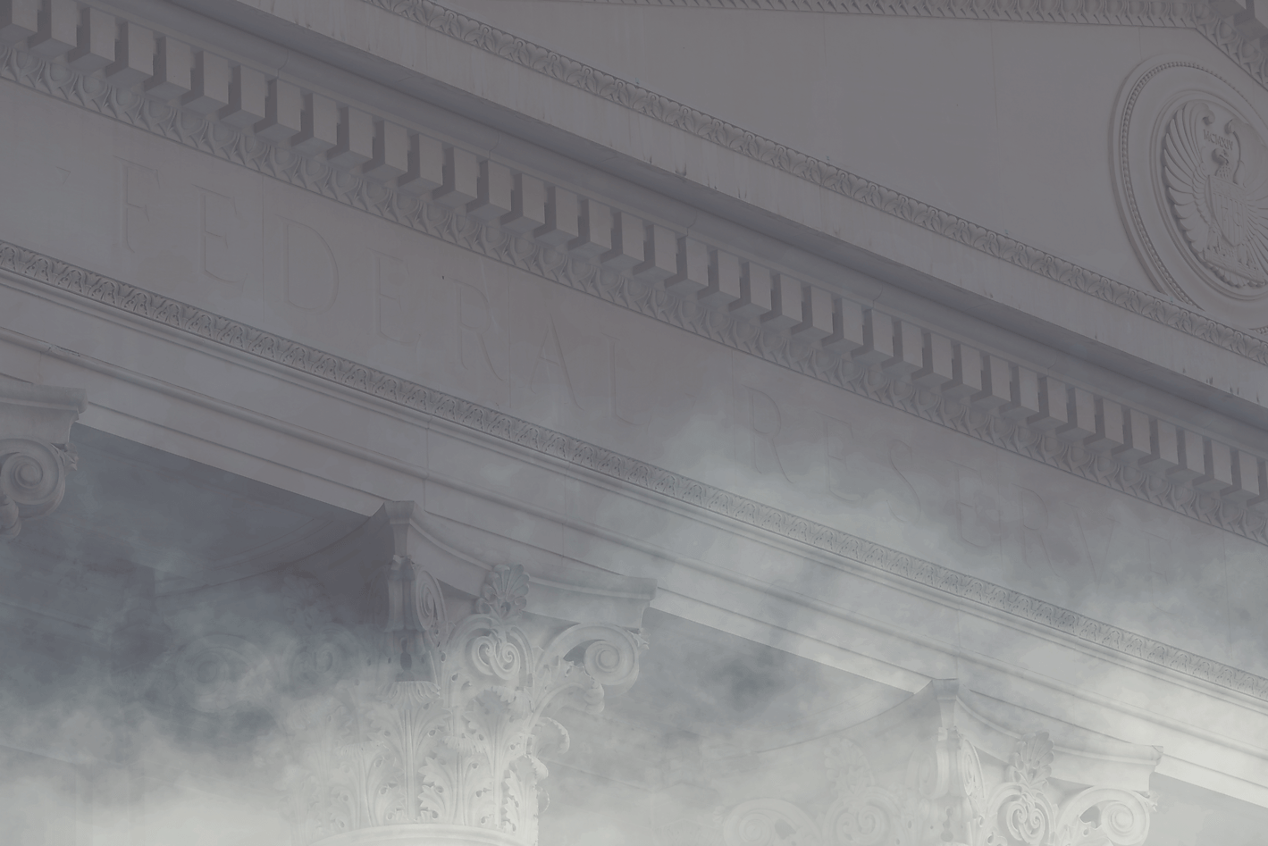 Facade of the Federal Reserve building partially covered in fog.