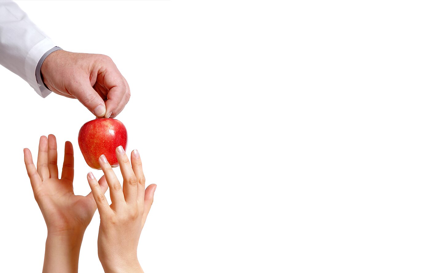 A doctor placing an apple into the hands of a patient.
