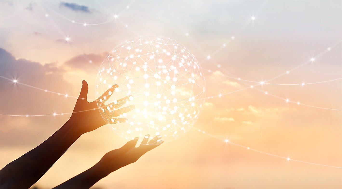 Abstract global network connection in hands on sunset background