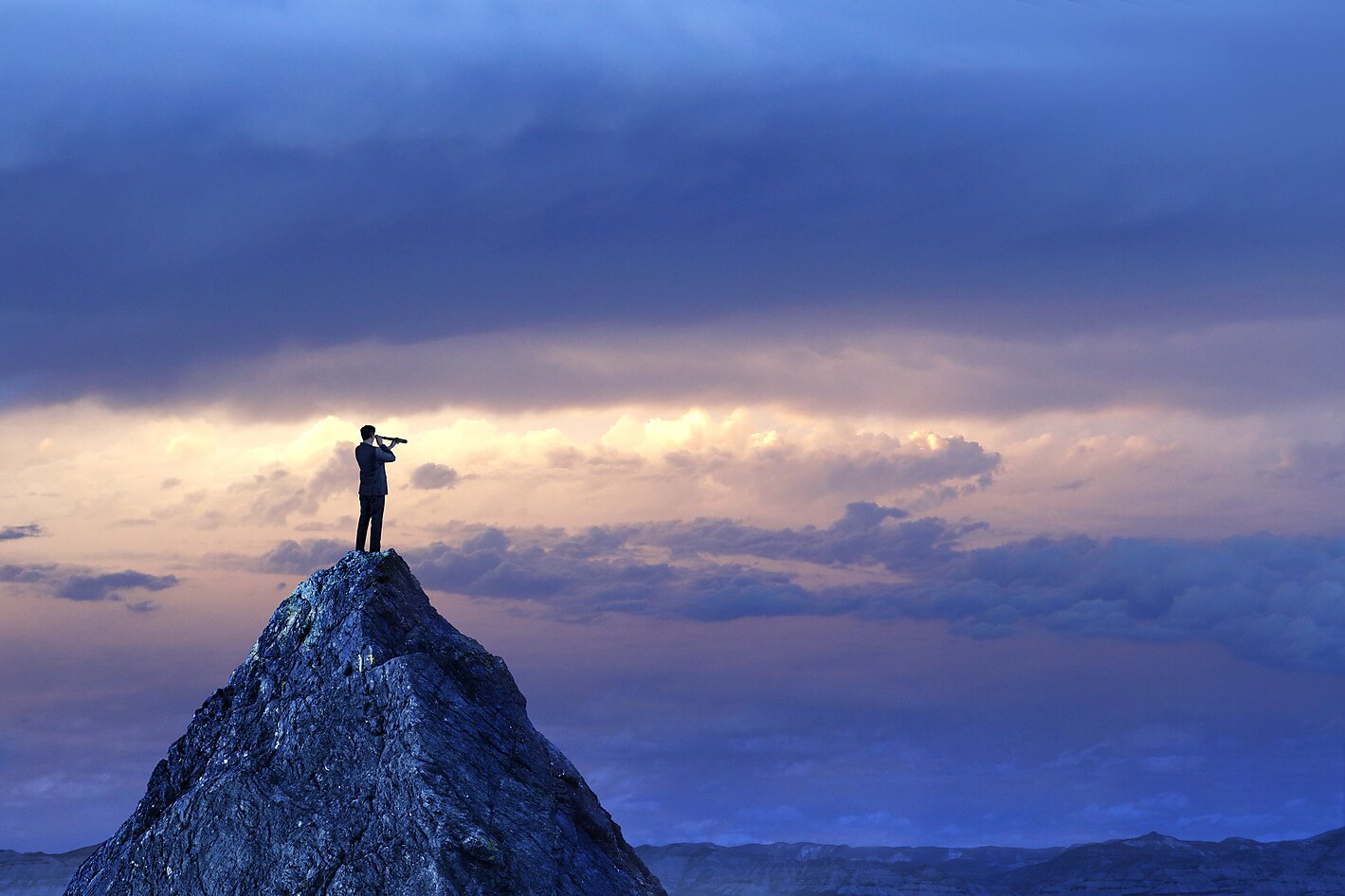 Businessman Standing Looking Through Spyglass On Mountain Peak