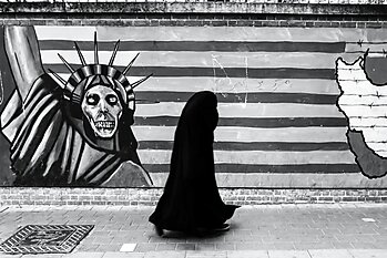 Woman walking past a mural