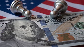 Hundred dollar bill with chess pieces and American flag