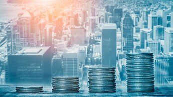 Stack of coins in front of a New York City background