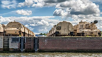 Military vehicles at a port for export.