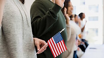 Immigrant swearing in with American flag