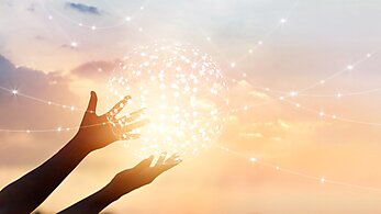 Abstract global network connection in hands on sunset background