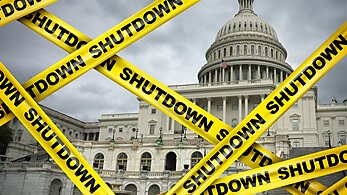 Congress covered in yellow tapes labeled "shutdown"