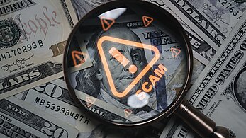 Scam Money with Magnifying Glass