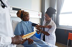 An African young female doctor taking blood pressure on a young patient in Cape Town South Africa