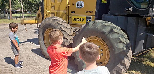Kids with construction equipment.