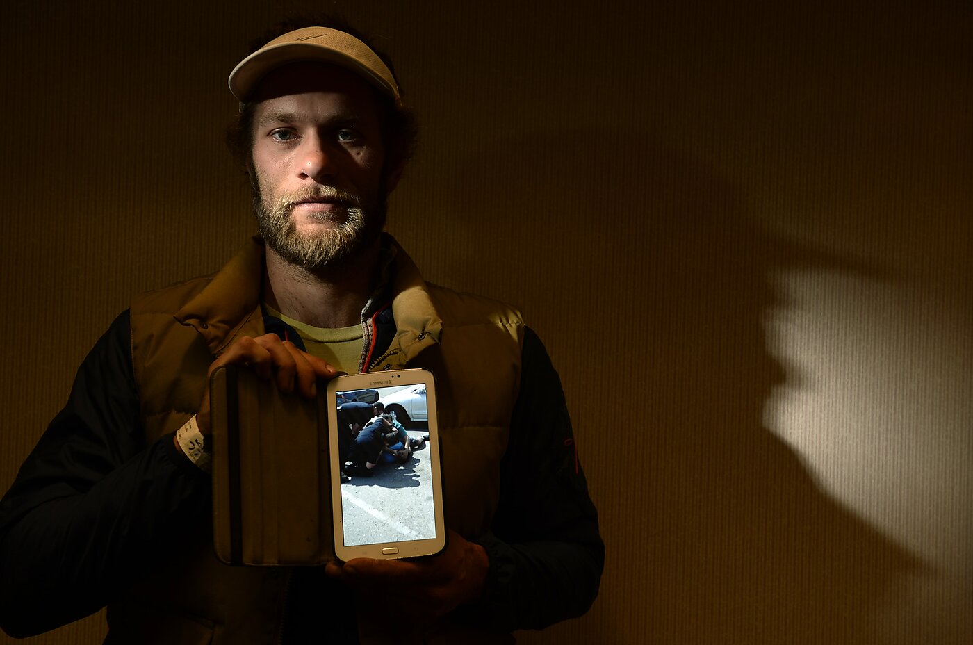 Levi Frasier holds his phone out to share the video he took of police