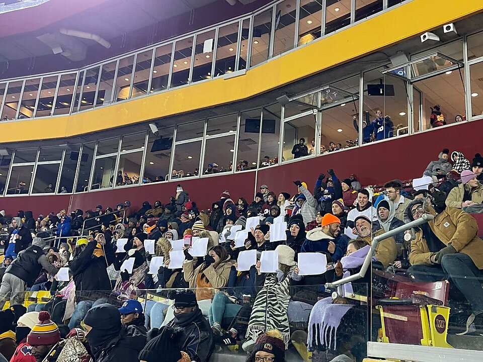 SFL protesters in stands of NFL game