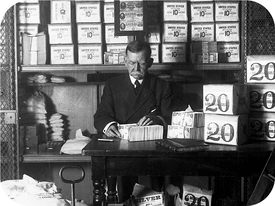 A Treasury Department official, surrounded by packages of newly minted currency, counts and wraps dollar bills. 