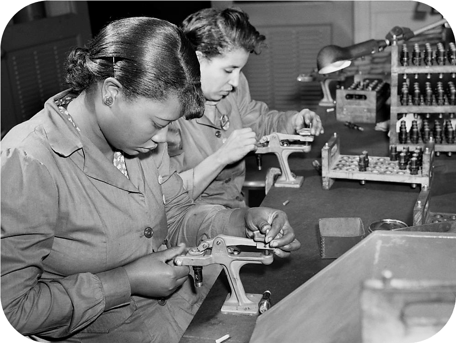 Two female factory workers reconditioning used spark plugs at Buick Plant July 1942.
