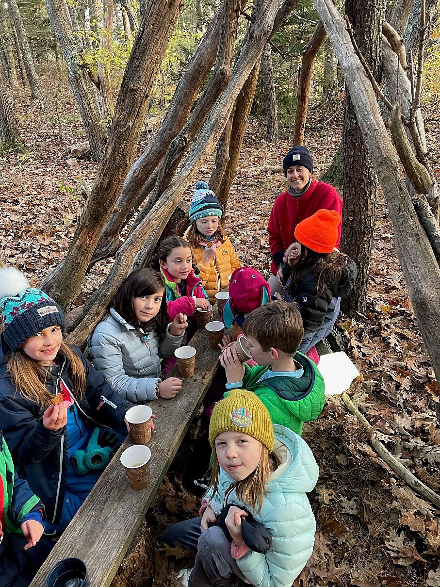 Kids learning in the woods.