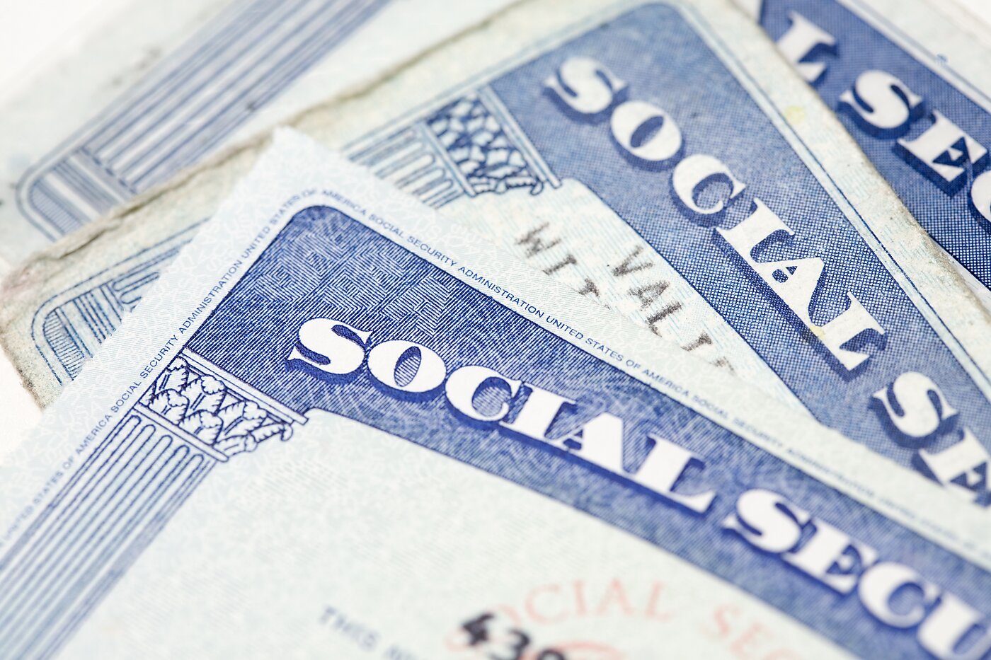 Three Social Security cards stacked.